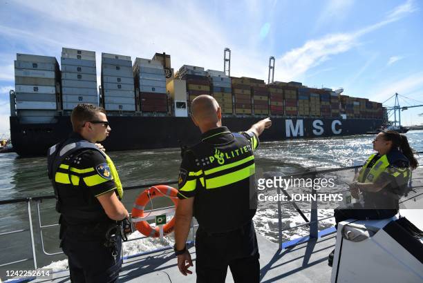 Seaport police officers observe a container ship arriving in Rotterdam's Harbour, in Rotterdam on August 1, 2022. - Drug seizures exploded in 2021 in...