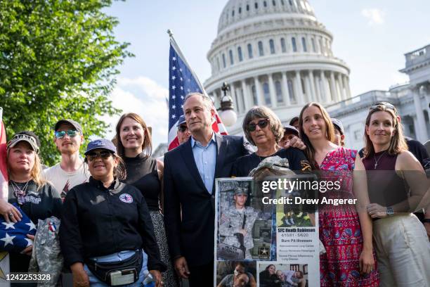 Second gentleman Doug Emhoff poses for a photo with veterans and families in support of the PACT Act, a bill to expand health care benefits for...