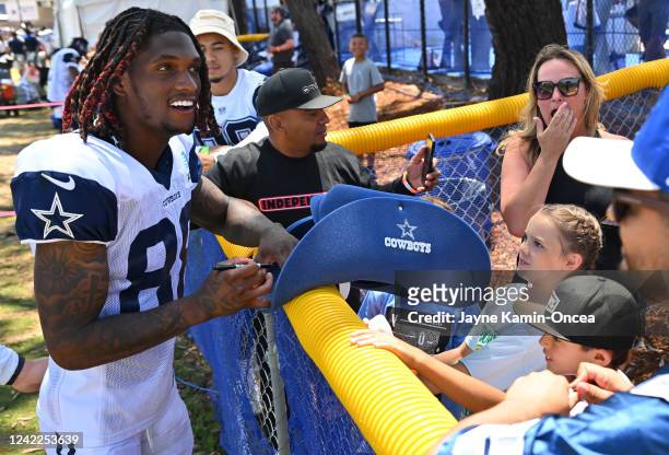 Wide receiver CeeDee Lamb of the Dallas Cowboys signs autographs during training camp drills at River Ridge Fields on August 1, 2022 in Oxnard,...