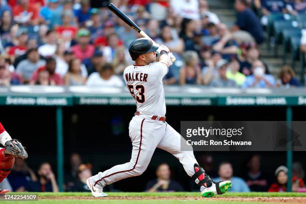 Christian Walker of the Arizona Diamondbacks hits a three-run home run off Cal Quantrill of the Cleveland Guardians during the fourth inning at...