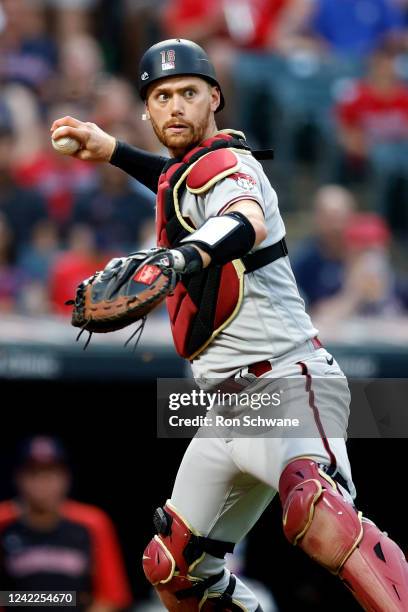 Carson Kelly of the Arizona Diamondbacks throws out Nolan Jones of the Cleveland Guardians at first base during the fourth inning at Progressive...