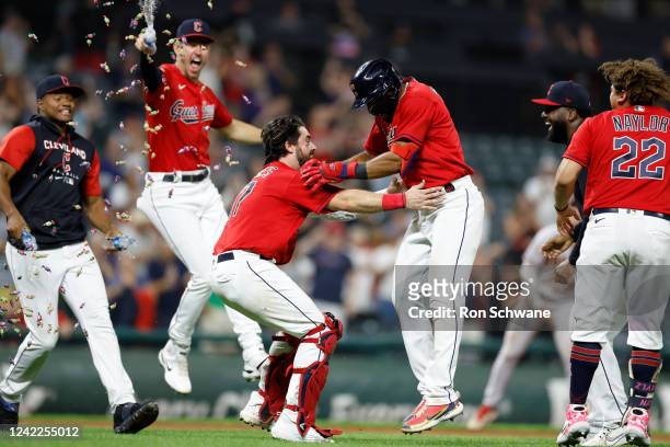 Amed Rosario of the Cleveland Guardians and Austin Hedges celebrate a 6-5 win over the Arizona Diamondbacks in 11 innings at Progressive Field on...
