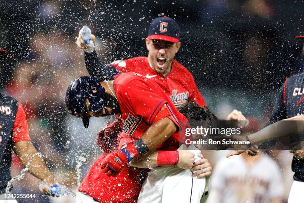 Amed Rosario of the Cleveland Guardians and Austin Hedges celebrate a 6-5 win over the Arizona Diamondbacks in 11 innings at Progressive Field on...