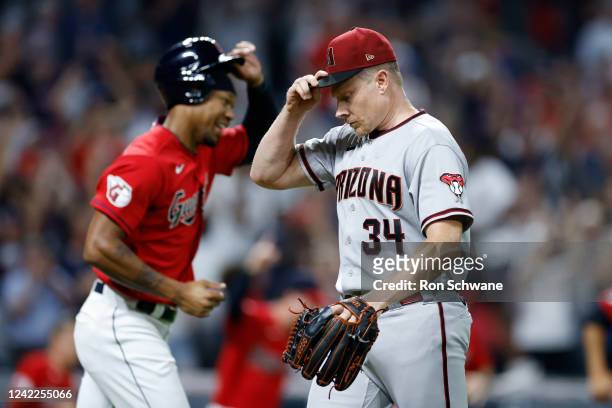 Mark Melancon of the Arizona Diamondbacks walks off the field after giving up the game-winning single to Amed Rosario of the Cleveland Guardians...