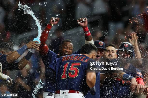 Gio Urshela of the Minnesota Twins celebrates his first career walk-off two-run home run with teammates as he touches home plate against the Detroit...