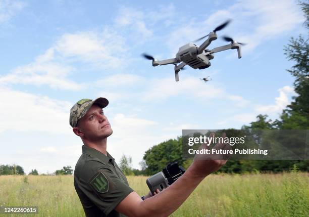 Serviceman looks at a UAV at the base where Ukrainian military personnel learn to control drones for combat missions, Kyiv Region, northern Ukraine....