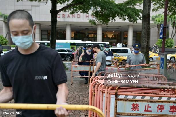 Workers build a security zone outside a local hotel in Taipei on August 2 where US House Speaker Nancy Pelosi might be staying. / The erroneous...