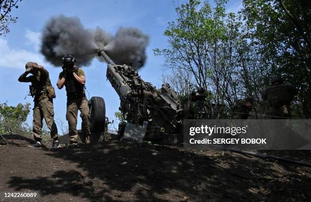 Ukrainian gunmen fire a US made M777 howitzer from their position on the front line in Kharkiv region on August 1 amid Russia's military invasion...