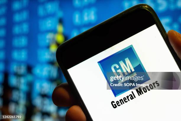 In this photo illustration, the American multinational automobile corporation, the General Motors logo is displayed on a smartphone screen.