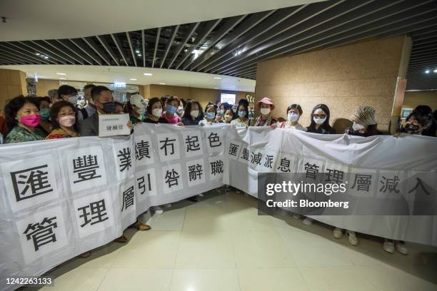 Attendees display a banner calling for the resignation of management at an HSBC Holdings Plc informal shareholders meeting in Hong Kong, China, on...