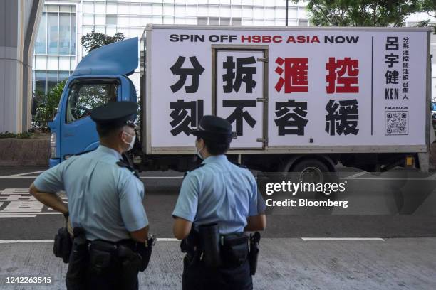 Van displaying 'Spin off HSBC Asia Now' drives outside an HSBC Holdings Plc informal shareholders meeting in Hong Kong, China, on Tuesday, Aug. 2,...