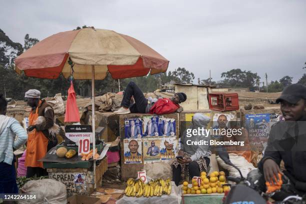 Vendor rests on a wall at a street market in the Kangemi district of Nairobi, Kenya, on Monday, Aug. 1, 2022. Kenyans will head to the polls on Aug....