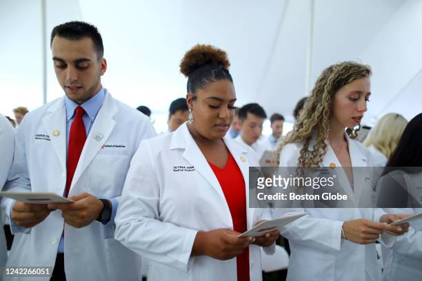 Boston, MA Students recite the Hippocratic Oath, to end the Boston University School of Medicine White Coat Ceremony. From left are Cameron Curley,...