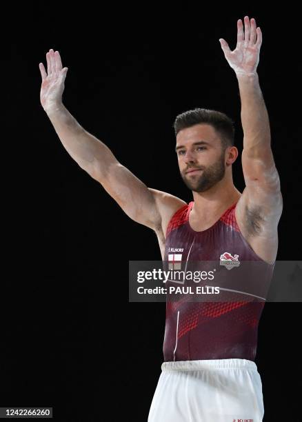 England's Giarnni Regini-Moran competes for second place and to take the silver medal in the men's parallel bars final artistic gymnastics event at...