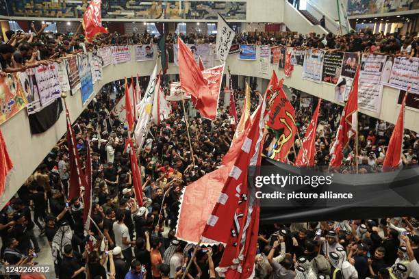 August 2022, Iraq, Baghdad: Supporters of Iraq's influential Shiite cleric Muqtada al-Sadr protest during a sit-in at the parliament building amid...