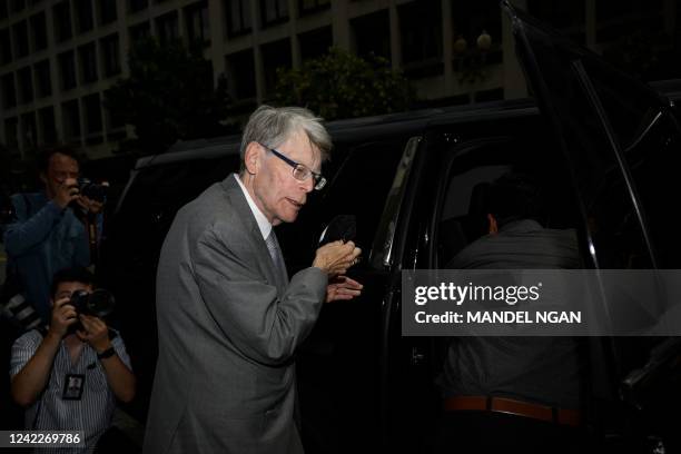 Author Stephen King takes his mask off before entering a vehicle as he departs the US District Court in Washington, DC, on August 2, 2022. - King...