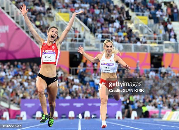 Wales' Olivia Breen celebrates next to England's Ali Smith as she wins the para-women's 100m T37/38 final athletics event at the Alexander Stadium,...