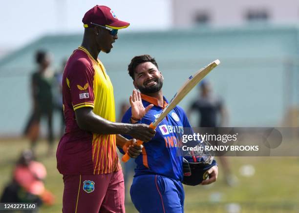 Rishabh Pant , of India, and Jason Holder , of West Indies, at the end of the third T20I match between West Indies and India at Warner Park in...