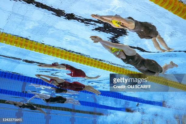 Australia's Mollie O'Callaghan competes to win and take the gold medal, as England's Anna Hopkin competes alongside in the women's 100m freestyle...