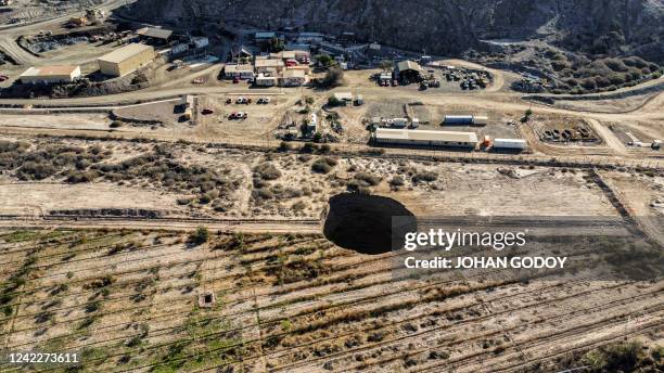 Aerial view taken on August 1 showing a large sinkhole that appeared over the weekend near the mining town of Tierra Amarilla, Copiapo Province, in...