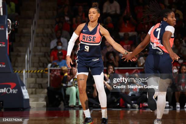 Natasha Cloud of the Washington Mystics high fives Ariel Atkins during the game against the Las Vegas Aces on August 2, 2022 at Entertainment &...