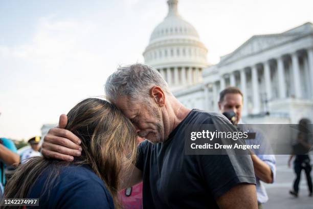 Comedian and activist Jon Stewart hugs Rosie Torres, wife of veteran Le Roy Torres who suffers from illnesses related to his exposure to burn pits in...