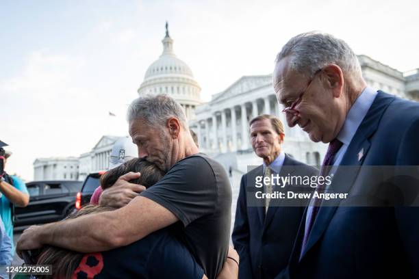 Comedian and activist Jon Stewart hugs Rosie Torres, wife of veteran Le Roy Torres who suffers from illnesses related to his exposure to burn pits in...