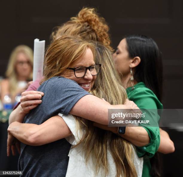 Representative Sharice Davids shares a group hug with women during the pro-choice Kansas for Constitutional Freedom primary election watch party in...