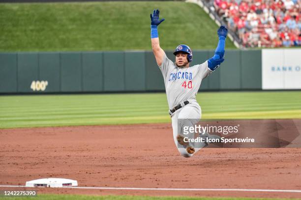 Chicago Cubs designated hitter Willson Contreras slides into third with a triple during a game between the Chicago Cubs and the St. Louis Cardinals...