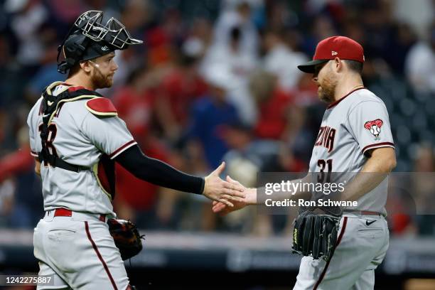 Carson Kelly and Ian Kennedy of the Arizona Diamondbacks celebrate a 6-3 win against the Cleveland Guardians at Progressive Field on August 02, 2022...