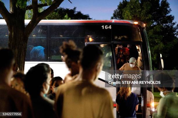 Migrants from Venezuela, who boarded a bus in Del Rio, Texas, disembark within view of the US Capitol in Washington, DC, on August 2, 2022. - Since...