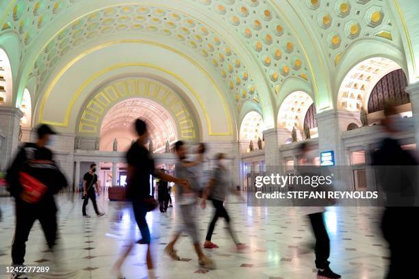 Migrants from Venezuela, who boarded a bus in Del Rio, Texas, walk through Union Station after disembarking within view of the US Capitol in...