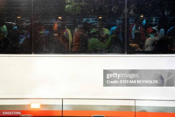 Migrants from Venezuela, who boarded a bus in Del Rio, Texas, wait to disembark within view of the US Capitol in Washington, DC, on August 2, 2022. -...