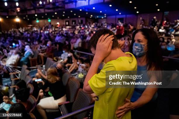 July 28: Whitney Ellenby comforts a boy with autism as approximately 500 people with Autism Ambassadors watch a special sensory friendly showing of...