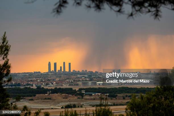 Summer storm is seen near the skyscrapers of the Four Towers Business Area. Rain and hail have reached the city of Madrid during a summer storm,...