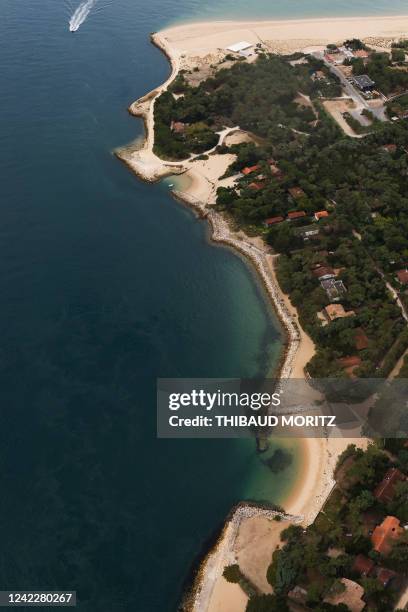 This aerial view taken on July 29 shows beaches and houses in the south tip of Cap Ferret, in the Bay of Arcachon, on the Atlantic coast in...