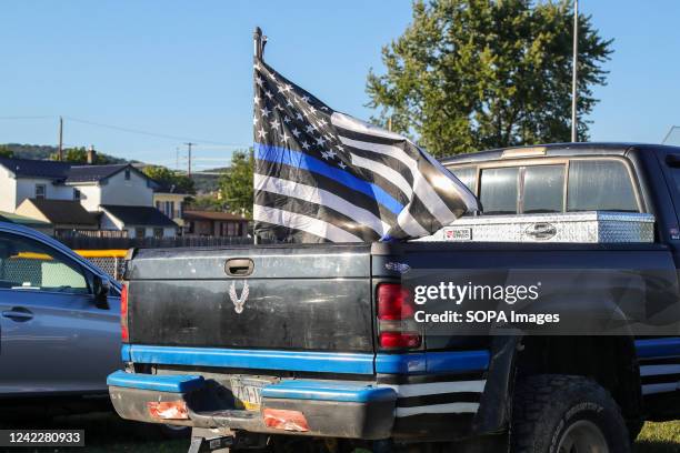 Pickup truck with a "thin blue line" flag is parked at Washies Playground in Danville, during a National Night Out event. Police departments, fire...