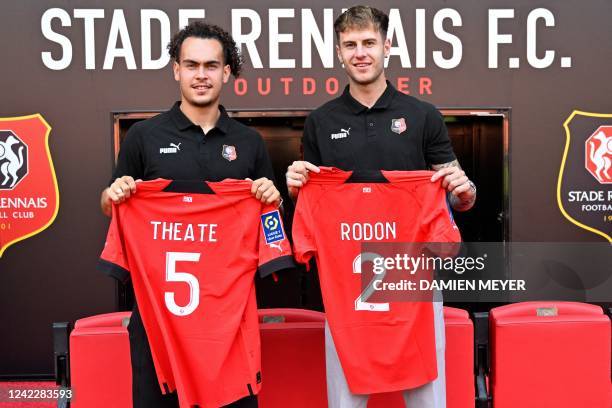 Stade Rennais' newly recruited defenders Belgium's Arthur Theate and Wales' Joe Rodon pose on the pitch during their presentation at the Roazhon Park...