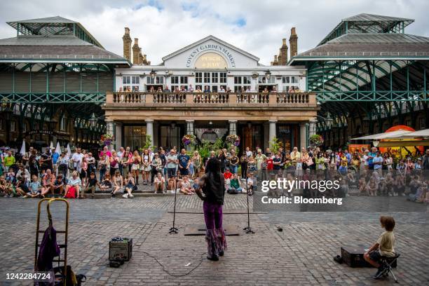 Crowd of tourists watch a street performer in Covent Garden in London, UK, on Wednesday, Aug. 3, 2022. It's never been more expensive to get a hotel...