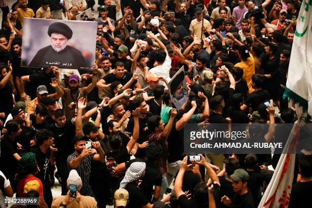 Supporters of Iraqi cleric Moqtada Sadr , wave flags as they occupy the Iraqi parliament for a fifth consecutive day, in protest at a nomination for...