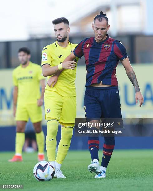 Francisco Javier Hidalog, Son of UD Levante and Alex Baena of of Villarreal CF battle for the ball during the Pre-Season Friendly match between...