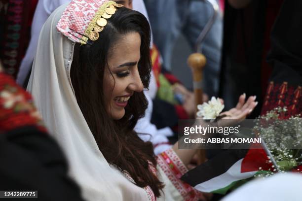 Palestinian bride is dressed in a traditional outfit on her wedding day during the Palestinian Heritage Week in the town of Birzeit near the West...