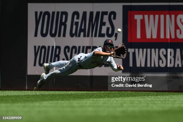Riley Greene of the Detroit Tigers dives but can't catch a ball hit by Byron Buxton of the Minnesota Twins in the eighth inning of the game at Target...