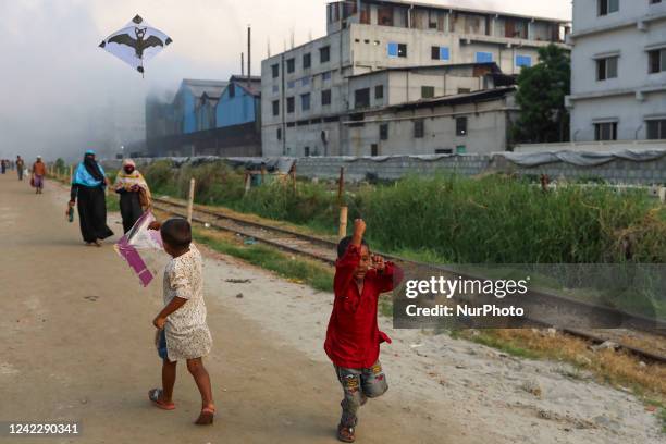 Women and children are vulnerable condition an air polluted area as smoke rises from a re-rolling mill in Dhaka, Bangladesh, August 03, 2022. Air...