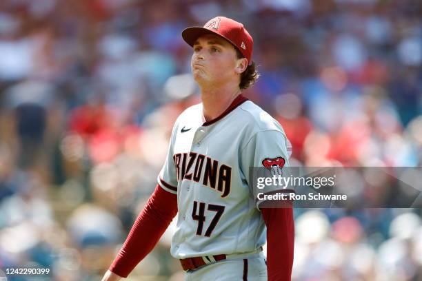 Tommy Henry of the Arizona Diamondbacks walks off the field after giving up three runs during the fifth inning against the Cleveland Guardians at...