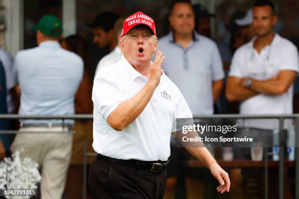 Former President Donald Trump yells over to the crowd at the 16th tee during the 3rd round of the LIV Golf Invitational Series Bedminster on July 31,...