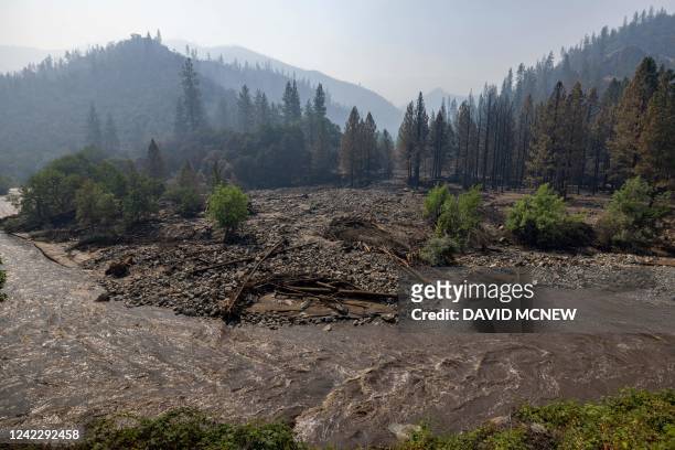 The Klamath River runs brown with mud after flash floods hit the McKinney Fire in the Klamath National Forest near Yreka, California, on August 3,...