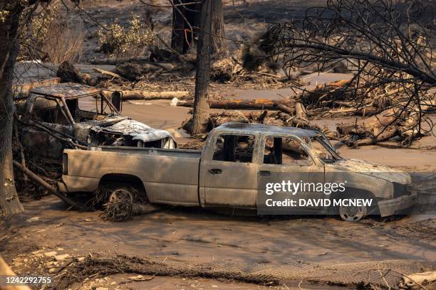 Vehicles that burned and were then caught in a flash flood are seen at the McKinney Fire in the Klamath National Forest near Yreka, California, on...