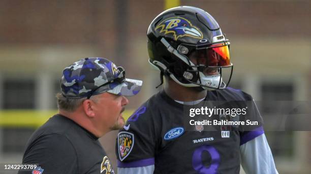 Baltimore Ravens quarterback Lamar Jackson talks with offensive coordinator Greg Roman during practice on July 29, 2022. Jackson&apos;s personal...