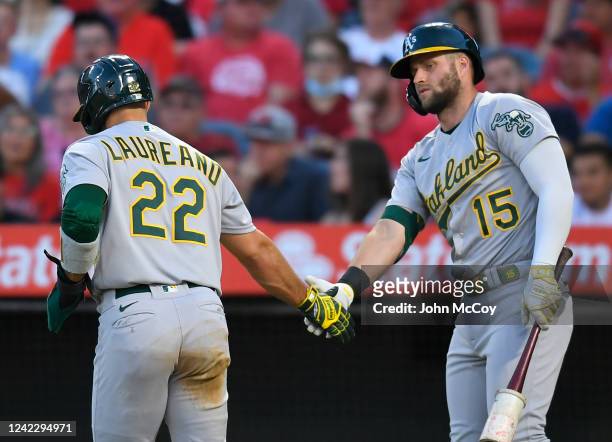 Ramon Laureano of the Oakland Athletics celebrates scoring on a single off the bat of Sean Murphy with Seth Brown against the Los Angeles Angels in...